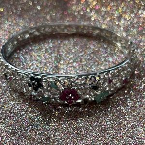 Sterling silver bracelet with flowers made of gemstones.